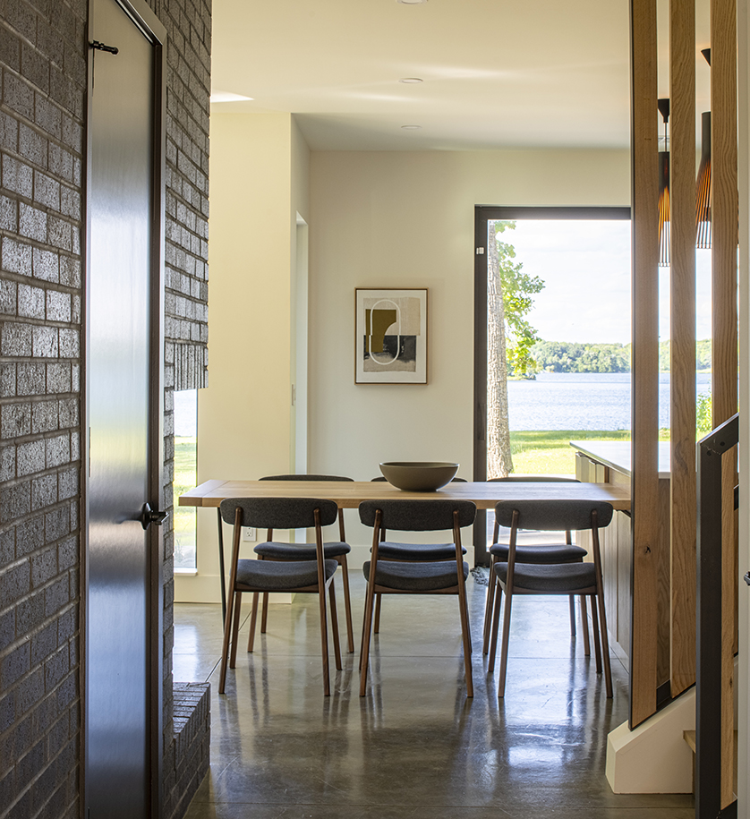 Lake cabin with Errol chairs around a table in the dining area.