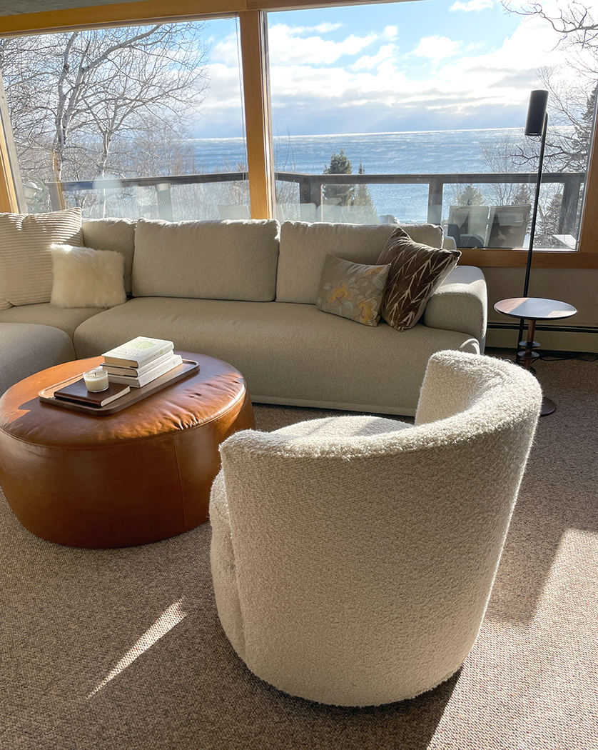 Living room furniture in sunlight overlooking Lake Superior